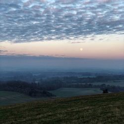 Scenic view of field against sky during sunset