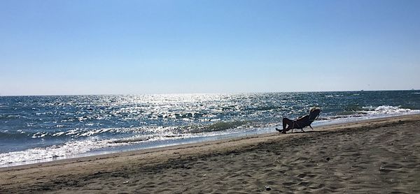 Scenic view of beach against blue sky