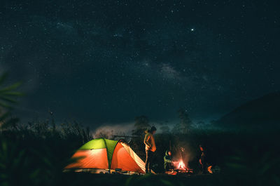 Group of people against sky at night