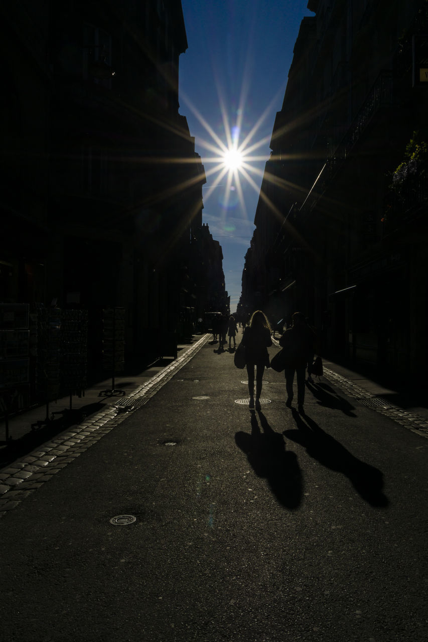 PEOPLE WALKING ON ROAD IN CITY