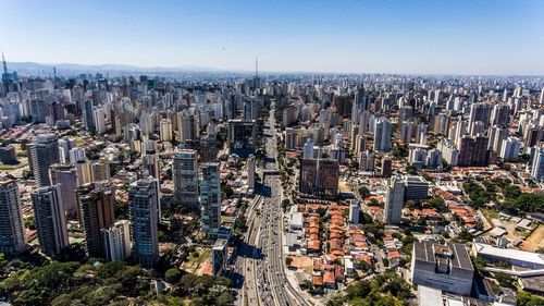 Aerial view of city against clear blue sky