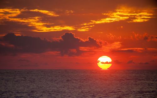 Scenic view of sea against orange sky