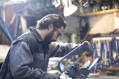 Young plumber technician working in workshop