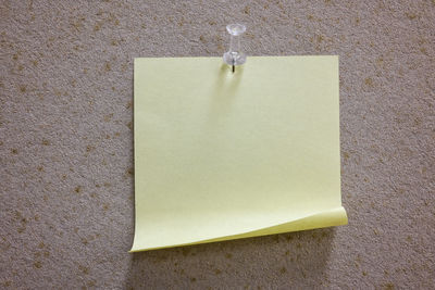 High angle view of paper hanging on wall