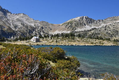 Scenic view of mountains against clear blue sky