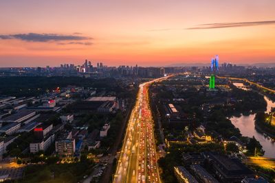 High angle view of illuminated buildings against sky during sunset