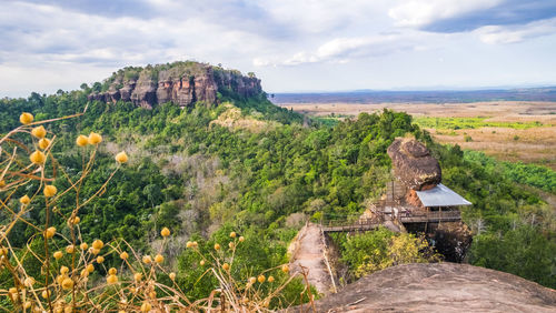 Castle on mountain against cloudy sky