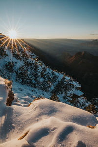 Scenic view of landscape against sky during winter