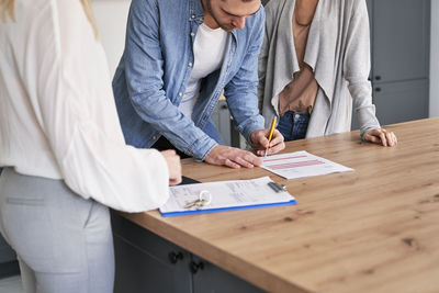 Midsection of business colleagues working at office