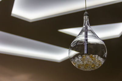 Low angle view of light bulbs hanging from ceiling