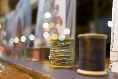 Close-up of thread spools on table at workshop