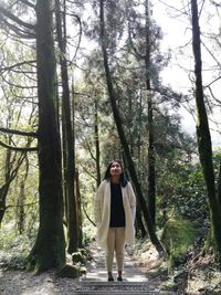 Woman standing in forest