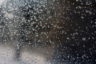 Full frame shot of wet glass window during rainy season