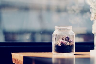 Close-up of soil in glass jar on table