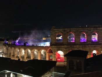 Illuminated building against sky at night