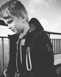 Boy looking at camera against sky