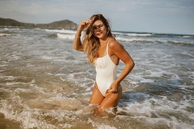 Young woman standing in water