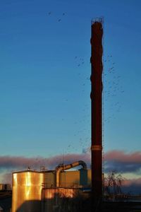 Factory against clear blue sky