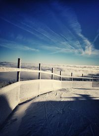 Close-up of snow covered landscape against blue sky