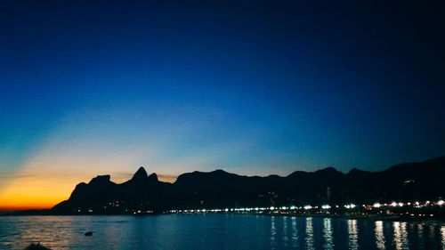 Scenic view of sea against sky at dusk