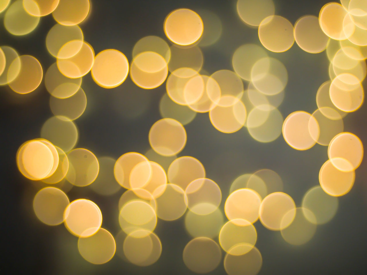 DEFOCUSED IMAGE OF ILLUMINATED LIGHTS AT NIGHT