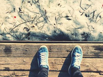 Low section of man standing on water