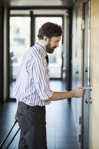 Businessman opening hotel door with cardkey