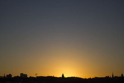 Silhouette of city at sunset