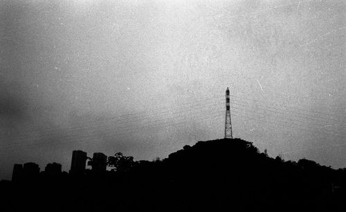 Low angle view of silhouette trees against sky