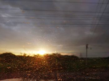 Scenic view of field against sky during sunset