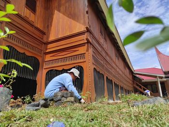 Man sitting by building