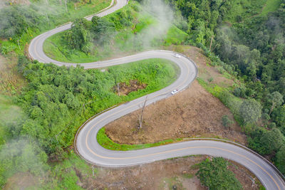 High angle view of winding road amidst trees