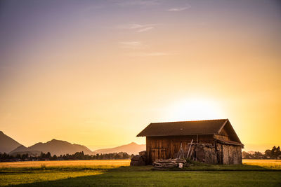 Built structure on field against sky during sunset hdr