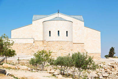 Low angle view of building against clear blue sky