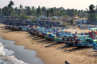 Boats moored on beach against sky