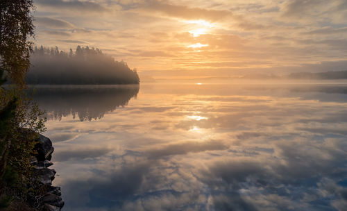 Scenic view of clouds over sea during sunset