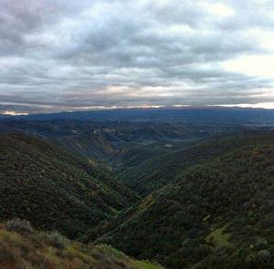 Scenic view of mountains against cloudy sky