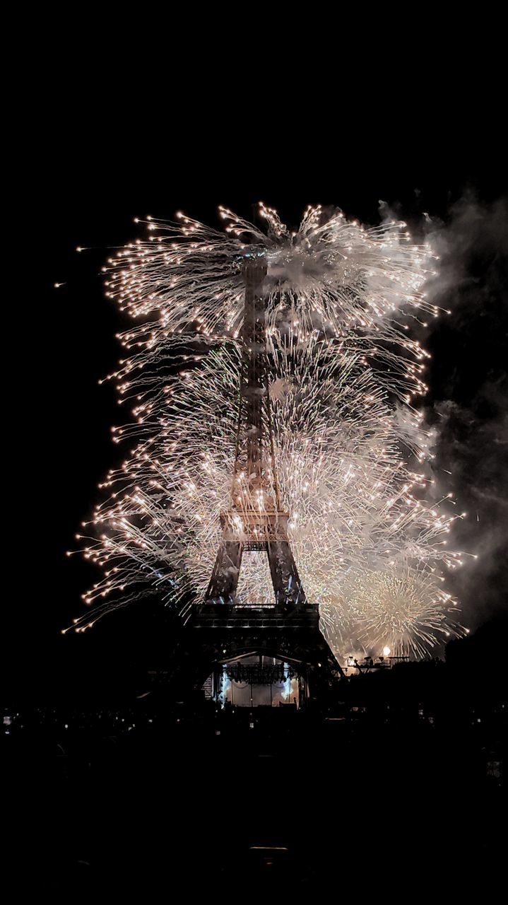 fireworks, motion, night, arts culture and entertainment, exploding, firework display, illuminated, celebration, recreation, event, darkness, long exposure, no people, nature, blurred motion, firework - man made object, outdoors, architecture, sky, light, new year's eve, water, glowing