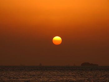 Scenic view of sea against orange sky