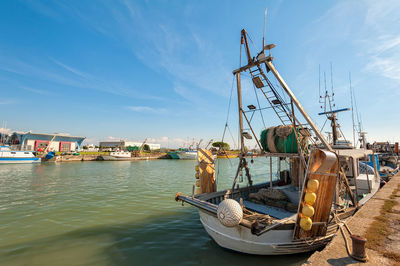 Boats moored at harbor