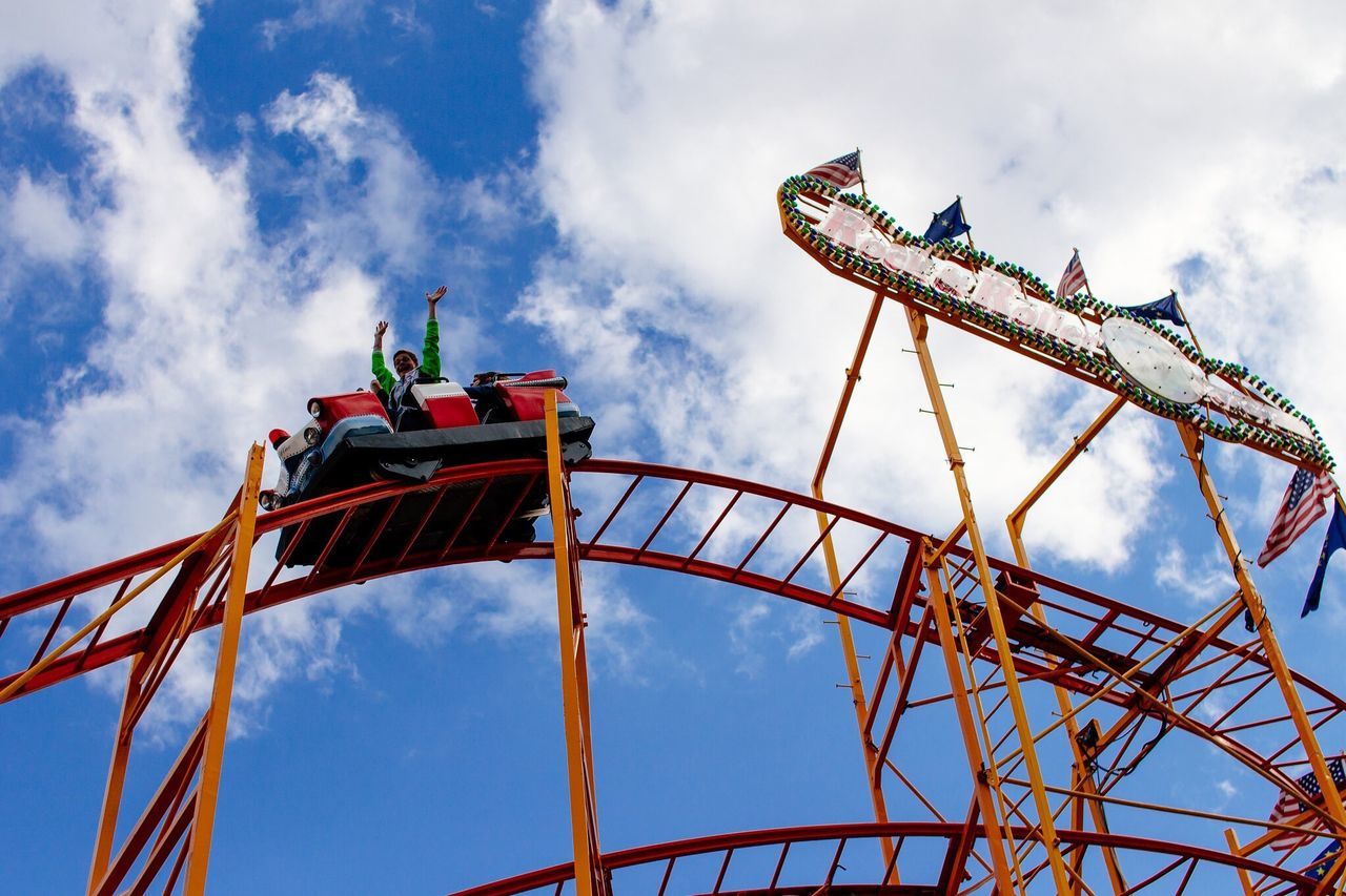 low angle view, amusement park, sky, amusement park ride, ferris wheel, arts culture and entertainment, built structure, cloud - sky, architecture, metal, cloud, cloudy, metallic, day, outdoors, fun, fairground ride, no people, tall - high, blue