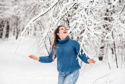 Full length of woman standing in snow