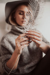 Midsection of woman holding hat