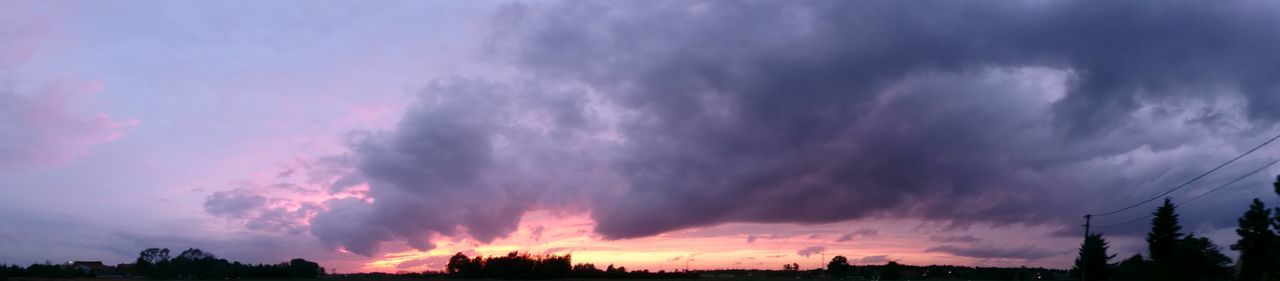 sky, silhouette, sunset, cloud - sky, beauty in nature, scenics, low angle view, tranquility, tree, cloudy, tranquil scene, nature, cloud, dramatic sky, dusk, idyllic, weather, outdoors, overcast, moody sky