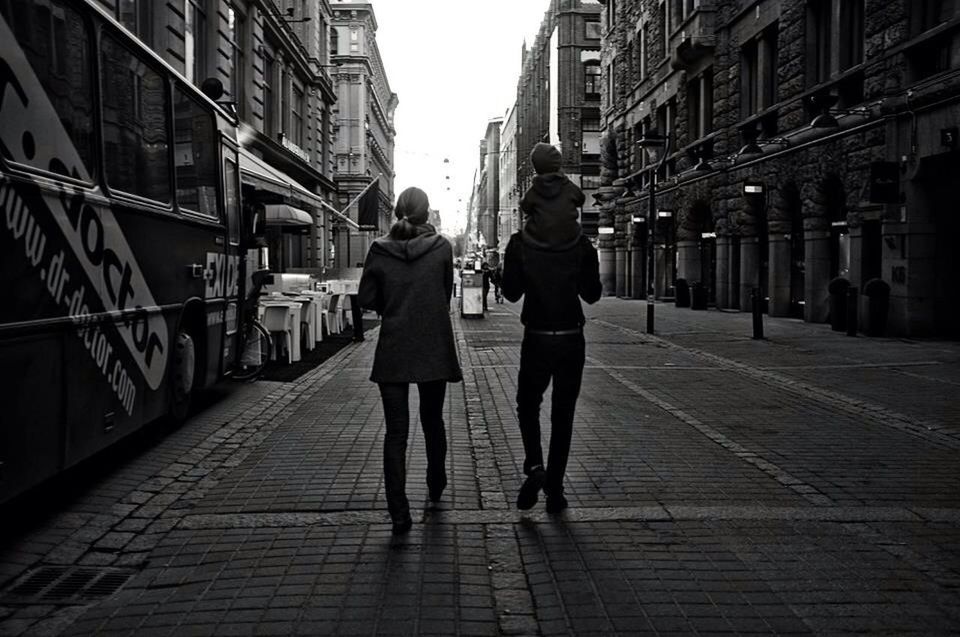 FULL LENGTH REAR VIEW OF PEOPLE WALKING ON FOOTPATH