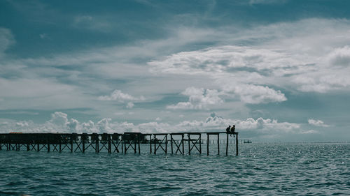 Pier over sea against sky