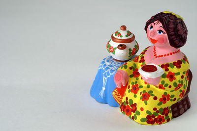 Close-up of figurine on table against white background