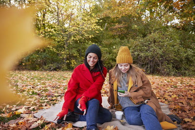 Happy friends in autumn scenery