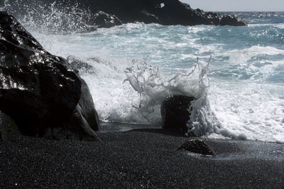 Waves splashing on rocks at shore