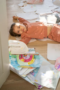 High angle view of cute girl sitting on table